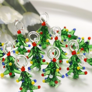 Macro detail of handmade green glass Christmas tree pendants with colorful beads