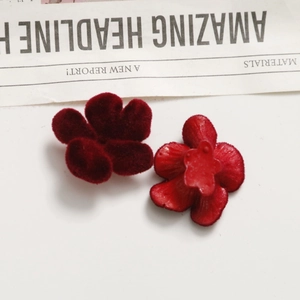 Close-up of red velvet and resin floral charms for DIY jewelry and hair accessories