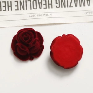 Macro view of vintage wine red velvet rose flower jewelry box for rings and earrings