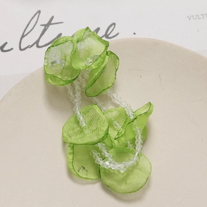 Detail of light green tulle flower petals and crystal beads for DIY hair accessory making