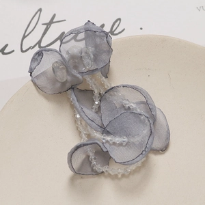 Detail of long fringe crystal tulle flower pendant showing elegant grey fabric petals