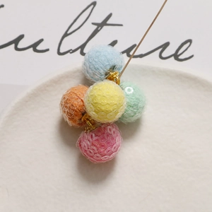 Detail of colorful sequined mesh balls with golden needles for DIY craft jewelry