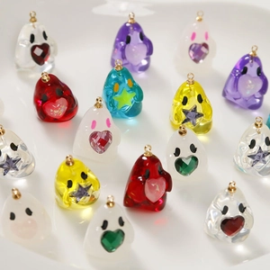Macro shot of colorful resin ghost charms with embedded hearts and stars for DIY jewelry
