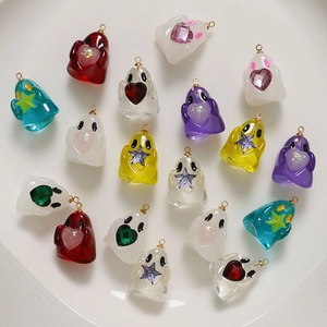 Detail of colorful resin ghost charms with gold rings for DIY jewelry making