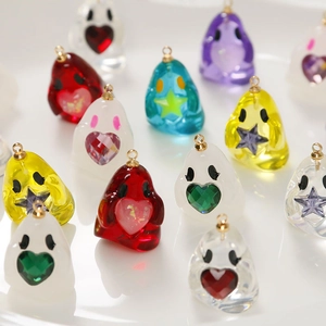 Macro shot of colorful resin ghost charms with heart and star icons for DIY jewelry