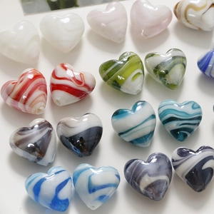 Macro detail of heart-shaped DIY beads with colorful ink-wash marble swirl textures