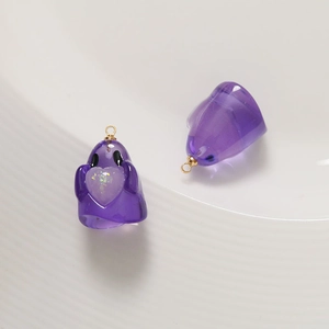 Macro detail of purple resin ghost charms with glitter hearts for DIY jewelry making
