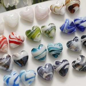 Macro detail of heart-shaped beads with marble texture and holes for jewelry making