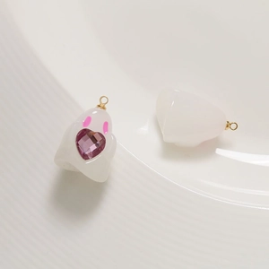Detailed view of DIY resin ghost charms with purple heart gems and golden jump rings