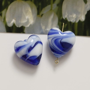 Detail of heart-shaped blue and white marble beads with gold T-pin for DIY jewelry