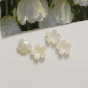 Macro detail of 12mm cherry blossom acrylic beads with pearl luster for DIY jewelry