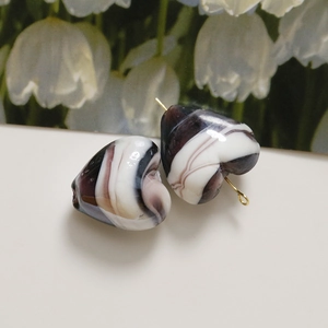 Pair of heart-shaped marble resin beads with purple swirls and gold metal pin attachments