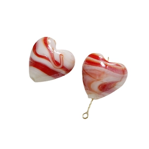 Handmade heart-shaped glass beads with red and white swirl patterns for DIY jewelry making