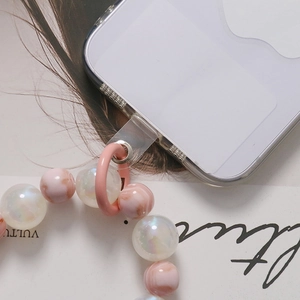 Universal beaded phone lanyard with marble pink and pearlescent beads on a clear phone case