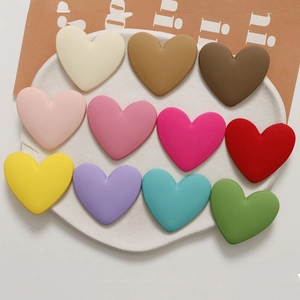Macro detail of matte macaron heart resin charms for DIY hair accessories and jewelry