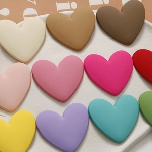 Macro shot of matte macaron resin heart charms for DIY jewelry and hair accessories