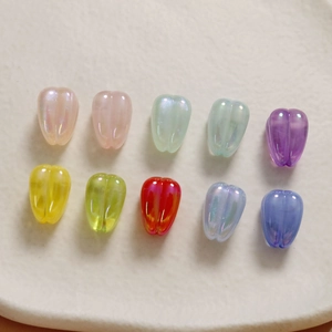 Detail of tulip shaped acrylic beads in translucent candy colors with a pearl finish