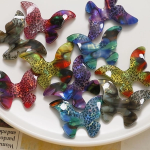Detail of colorful gradient leopard print acetate butterfly charms for DIY jewelry making