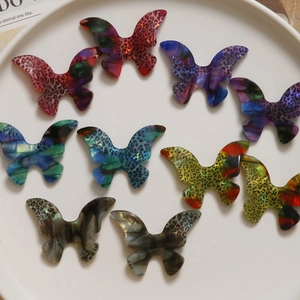 Colorful gradient acetate butterfly charms in leopard and marble patterns for DIY crafts