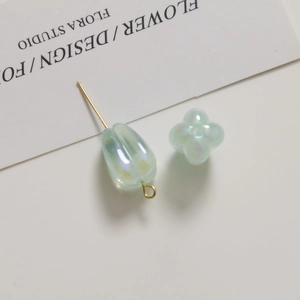 Macro detail of AB iridescent light green tulip flower and leaf acrylic DIY beads