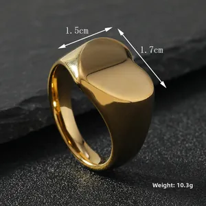 Macro side view of polished gold stainless steel signet ring on grey stone background