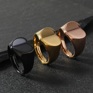 Detailed close-up of heart signet rings in black, gold, and rose gold polished finishes
