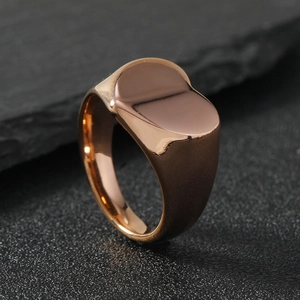 Polished rose gold stainless steel signet ring with smooth flat top on black stone