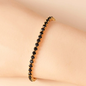 Classico bracciale tennis con pietre nere a taglio tondo e montatura oro a griffes