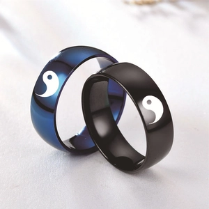 Detail of 8mm stainless steel Yin Yang couple rings in polished black and deep blue finish