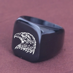 Detailed view of black polished square signet ring featuring a white eagle head engraving