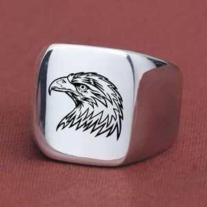 Macro view of square signet ring with engraved black eagle head on silver titanium steel