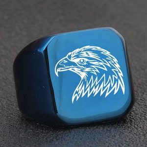 Macro shot of blue eagle head engraving on a square stainless steel punk style ring