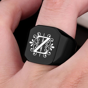 Close-up of matte black stainless steel signet ring with engraved letter Z and vintage patterns