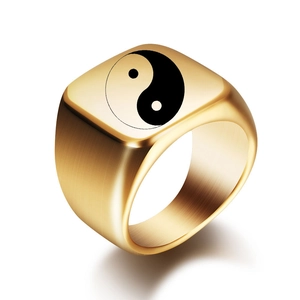 Detailed view of golden brushed stainless steel ring with Yin Yang Tai Chi symbol design