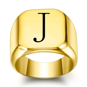 Polished gold signet ring featuring a square face and a black engraved letter J design