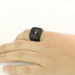 Dettaglio ravvicinato di un anello a sigillo nero con grafica di aereo sulla mano