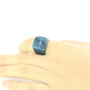 Dettaglio macro dell'anello a sigillo blu in acciaio inossidabile con aereo laser