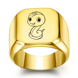 Macro detail of golden stainless steel ring featuring engraved cartoon zodiac snake design