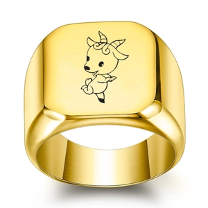 Macro shot of gold-plated signet ring featuring a minimalist cartoon goat engraving