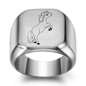 Macro shot of silver stainless steel signet ring with black horse silhouette engraving