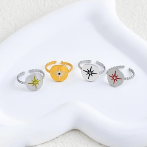 Set of four minimalist gold stainless steel open rings with star patterns in various colors