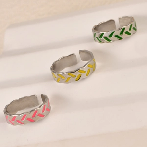 Three colorful wheat grain textured stainless steel open rings in green yellow and pink