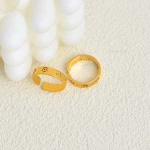 Minimalist gold open rings with hollow floral pattern and polished metal finish