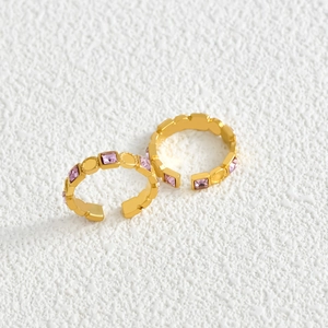 Elegant gold open ring set with square pink zircon stones on a clean white background