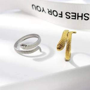 Macro view showing detailed snake scales texture on gold and silver adjustable rings