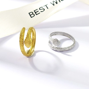 Detail showing snake rings with delicate scale texture in gold and silver finish