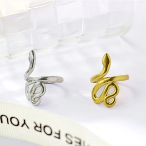 Detailed view of gold and silver snake rings with adjustable open band design