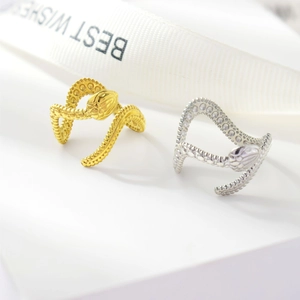 Close-up of gold and silver snake rings featuring detailed scales and adjustable open band