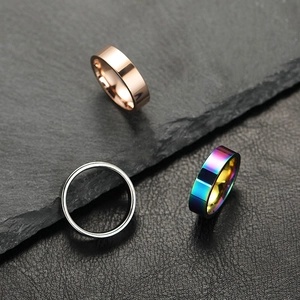 Macro detail of 6mm polished stainless steel rings in rose gold, silver, and rainbow finish