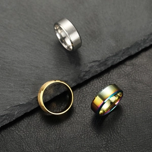 Detail van matte zilveren, gepolijste gouden en regenboogkleurige roestvrijstalen ringen